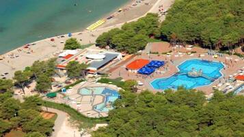 Relax on the beach or by the pool, surrounded by lush greenery and scenic views.