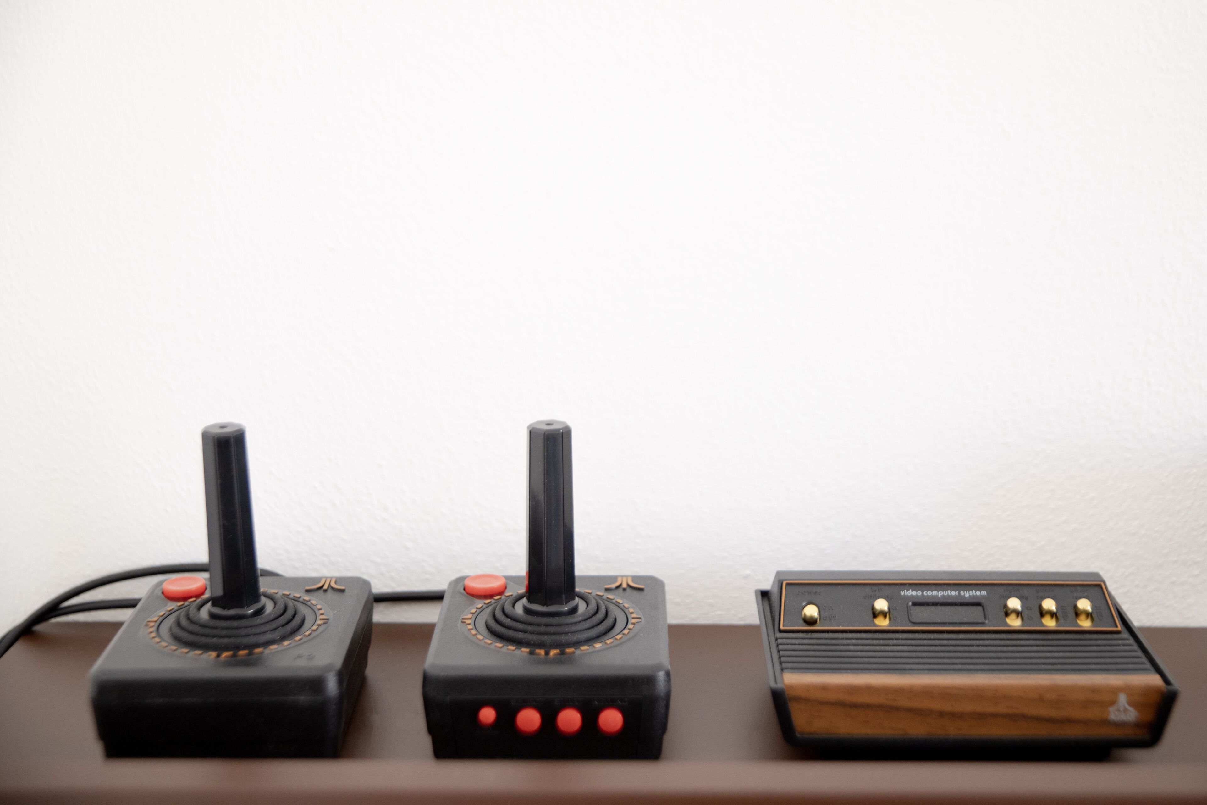 Three electronic devices on a brown surface.