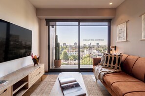 Superior Apartment | Living area | 52-inch LED TV with cable channels, TV, heated floors - Taman by Kukun (Mexico City)