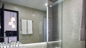 A modern bathroom with a glass-enclosed shower, a vanity with a sink and mirror, and a toilet. - Design Pool and 180º Rooftop N3 (Ciudad de Panamá)