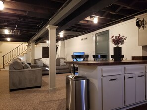 A modern kitchen with a stainless steel refrigerator, a wooden countertop, and a built-in oven.