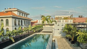 A rooftop swimming pool with a clear view of surrounding buildings, surrounded by potted plants. - Outstanding double appartment with pool and rooftop (Ciudad de Panamá)