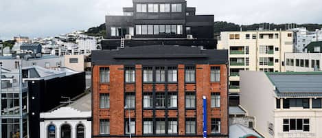 Un edificio de varios pisos con una fachada de ladrillo destacada y ventanas amplias.