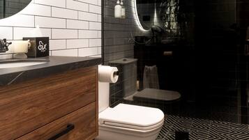 A modern bathroom with a black and white tiled floor, a wooden vanity, a white toilet, a glass shower enclosure, and a large mirror.