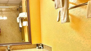 A bathroom with a toilet, sink, mirror, and towel rack. - Hotel M Morgantown - WVU Area (Morgantown)