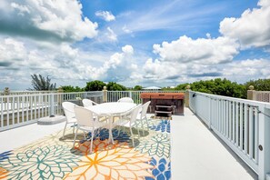Enjoy al fresco dining and cooking in a serene outdoor space with a barbecue grill and comfortable seating.