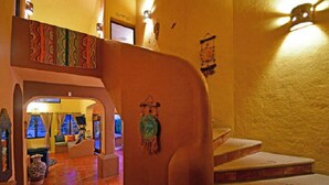 A staircase with a textured wall and a decorative hanging.