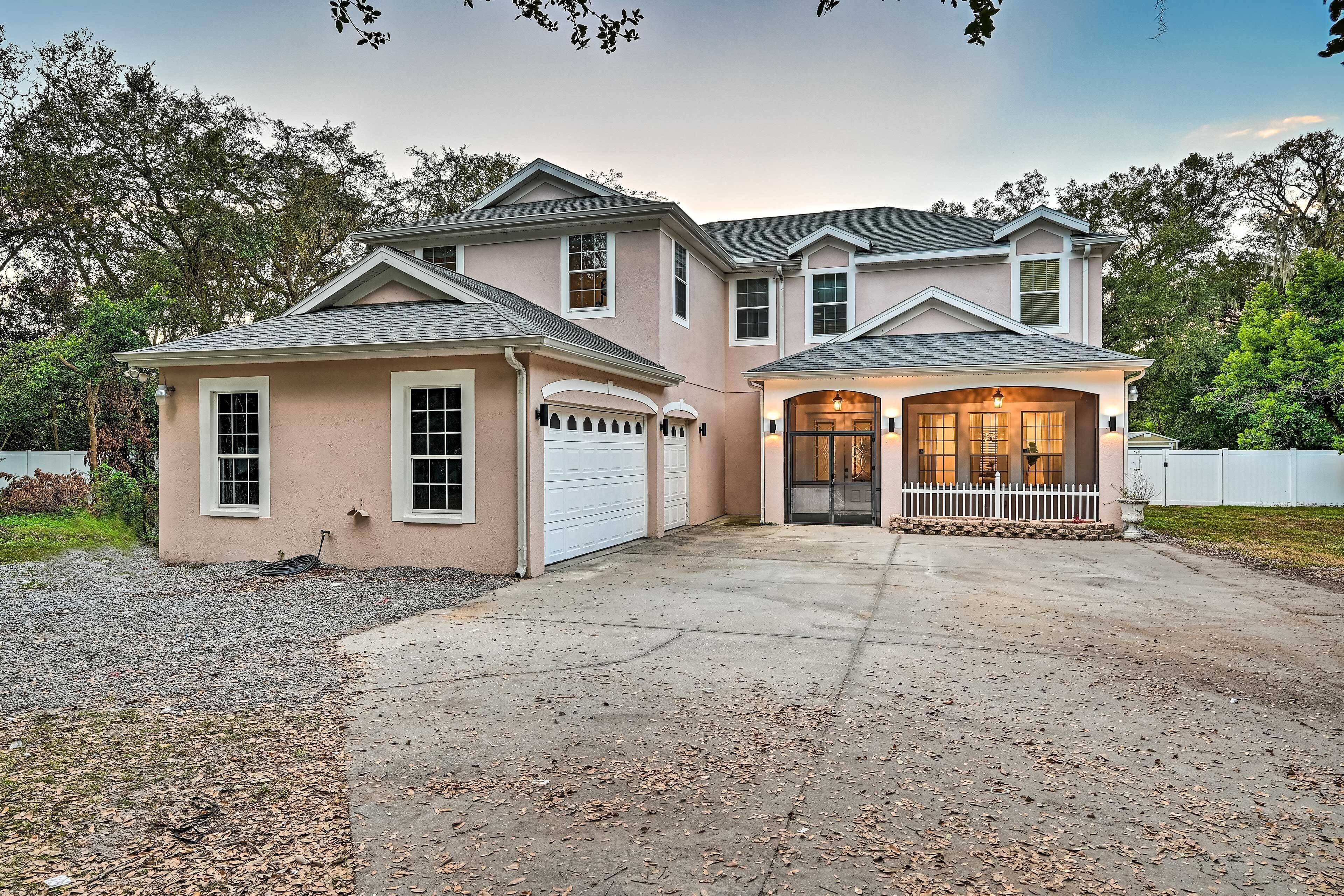 A two-story house with a garage, a covered porch, and a driveway.
