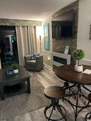 Relax in this inviting living room with a comfortable sofa, coffee table, and dining area.