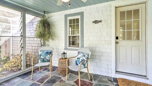 A porch with two wicker chairs, a hanging plant, and a lantern. - Steps to Dennis Village! 'The Blue Scallop' Home (Dennis)