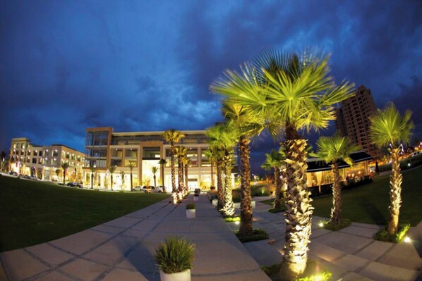 Situated on a lush lawn, this hotel features modern architecture with flat roofs and large windows.