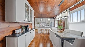Enjoy meals in this kitchen with a dining area for two, featuring a table and bench.