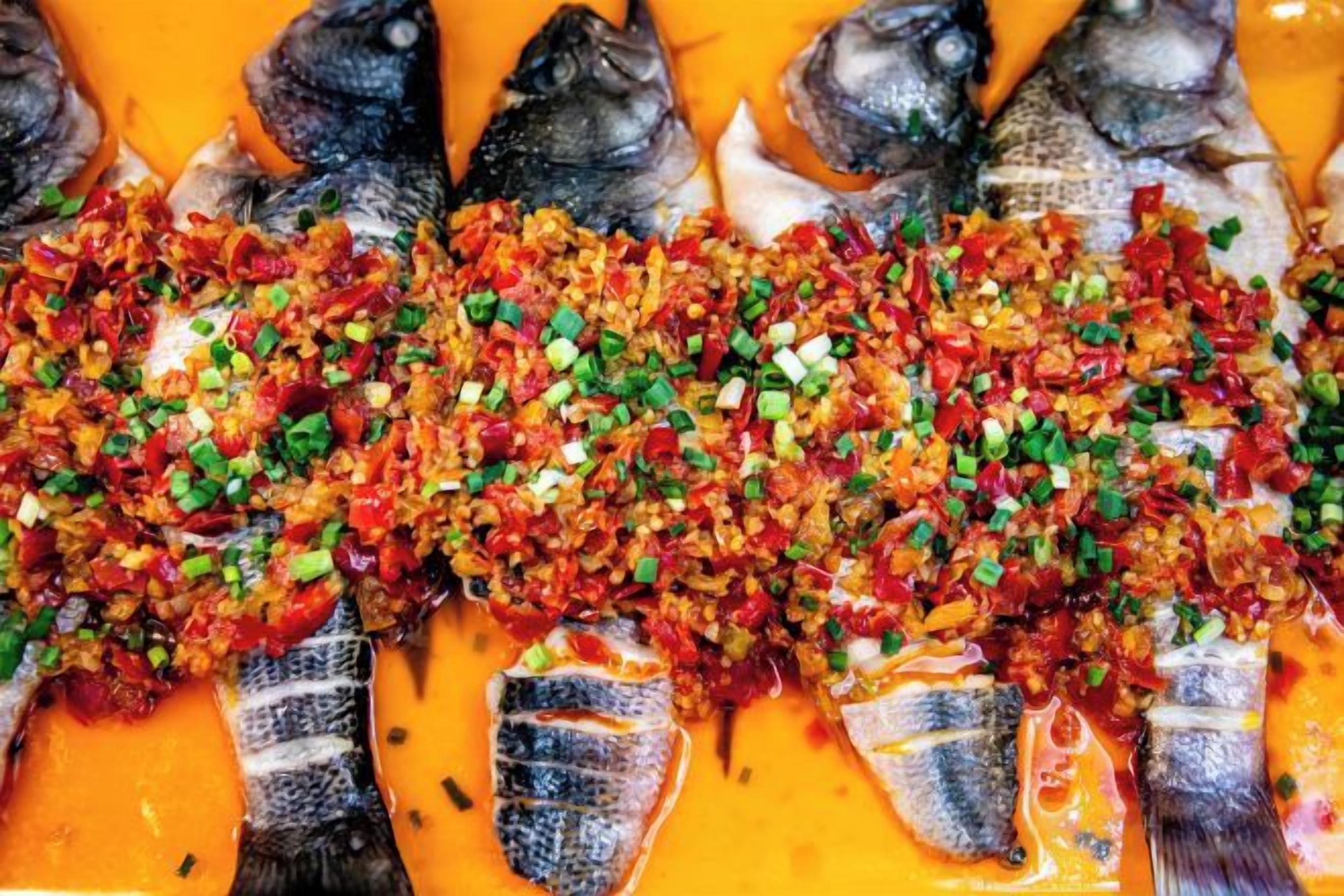 A row of fish with a spicy garnish.