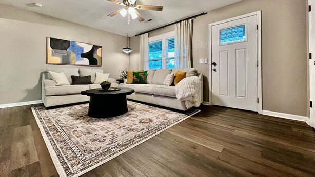 A living room with a ceiling fan, a patterned rug, a sofa, and a coffee table. - 3 BDR Ranch w/ Fenced yard, laundry, garage + more (Liberty Township)