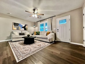 A living room with a ceiling fan, a patterned rug, a sofa, and a coffee table. - 3 BDR Ranch w/ Fenced yard, laundry, garage + more (Liberty Township)