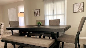A dining area with a rectangular table, four chairs, and a bench. - 3311 Evanston · Large Renovated 4 BDR + Close to DTWN + Laundry (Cincinnati)