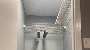 A walk-in closet with metal shelving, a door, and a wooden floor. - 5145 Porsche · Newly Remodeled 2 BDRM Ranch- Attached Home (Liberty Township)