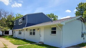 A two-story house with a dark blue roof and white exterior walls. - 219 Maxwell St - Unit A · Newly Renovated Franklin Flat (Franklin)