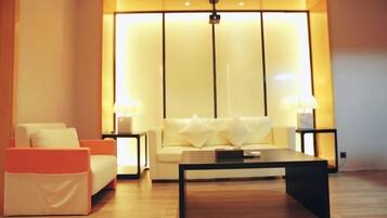 A modern living room with a sofa, a coffee table, and two lamps.