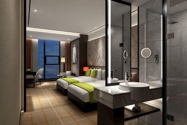 Una habitación de hotel moderna con una cama grande, una zona de estar independiente, un baño con un espejo amplio y vistas a la ciudad.
