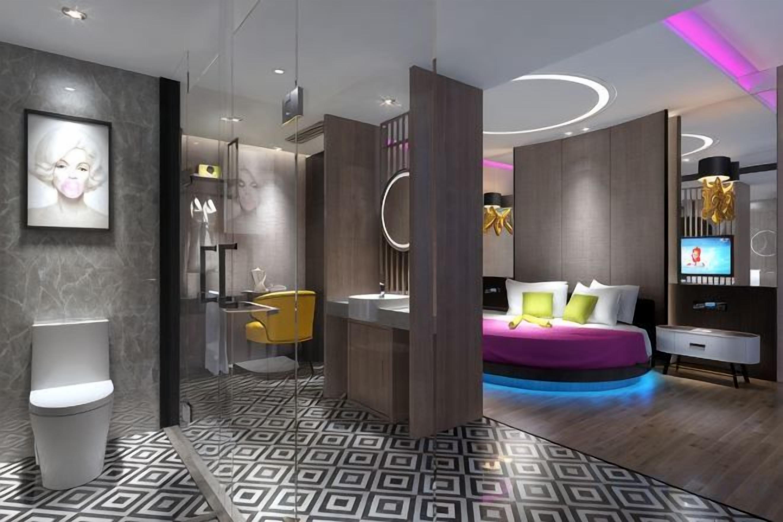 A modern bedroom with a bed, bedside table, and a TV.