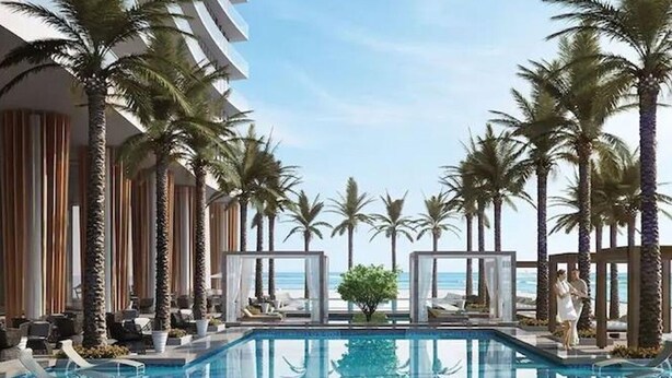 A pool area with lounge chairs, palm trees, and a view of the ocean. - Amazing apartment Lyfe Resort-& Residences- Ocean view! (Hollywood)