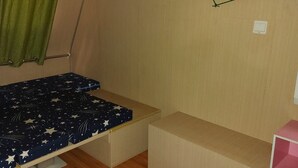 A compact room with a bunk bed, a small table, a green curtain, and a white air conditioning unit. - caravan trailer (New Taipei City)