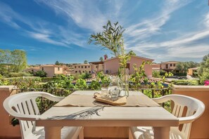 A table set outdoors with a view of a residential area, including houses and greenery.