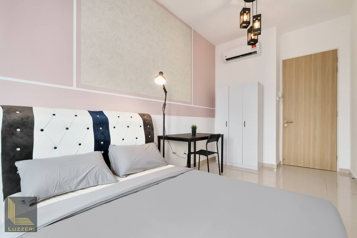 Une chambre à coucher moderne avec un lit, une table de chevet, une lampe et une armoire.