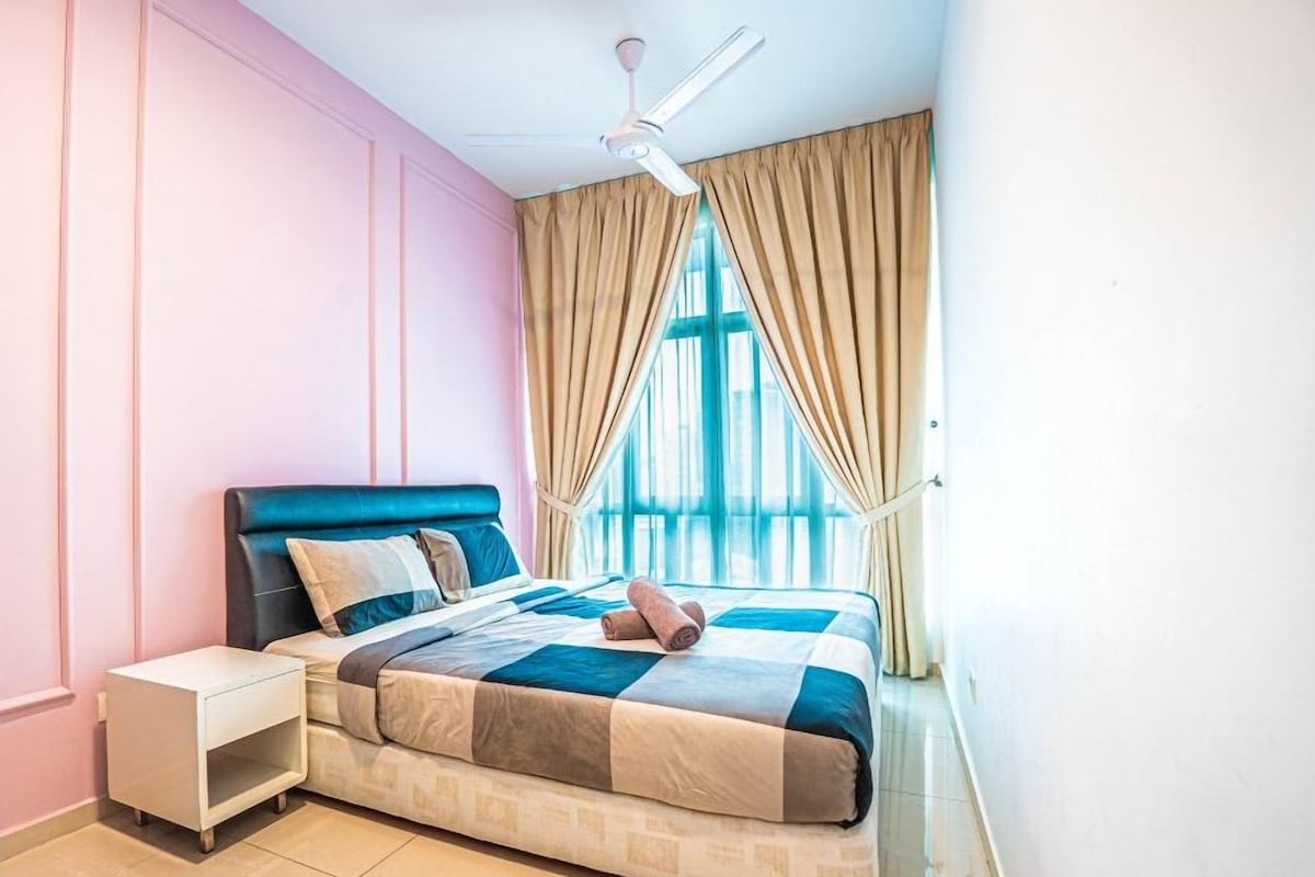 A bedroom with a bed, nightstand, and a ceiling fan.