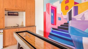A room with a pool table, wooden cabinets, a sink, and a colorful abstract painting. - Torretta by the Bay (Dunsborough)