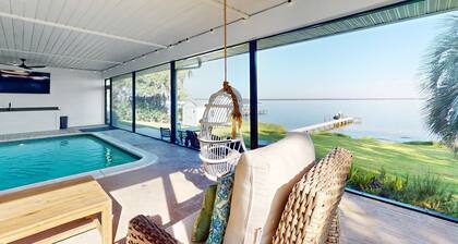 Renovated lakefront retreat with screened pool, private dock, patio, grill & W/D