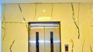 An elevator with a metallic finish, a wall with visible cracks, and a ceiling light fixture. - Hotel Star Holiday (Siddharthanagar)