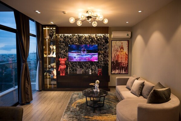 A modern living room with a large TV, a sofa, and a coffee table.