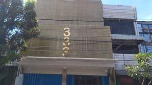 A building with a large number '3' on the facade, indicating it might be a hotel or commercial property. - BLOOMINGTON (Surabaya)