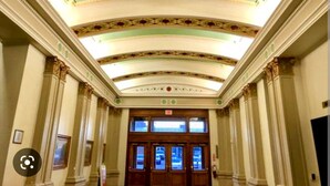 A grand hallway with a high ceiling, ornate decorations, and a large wooden door at the end. - Lush Rooftop Terrace  City views A luxurious stay in  Central Downtown Area
 (Louisville)