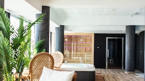 A modern spa area with a hot tub, wicker chairs, and a wooden reception desk. - Hôtel Barracuda & Spa, Centre Port, pieds dans l'eau, vue mer (Brest)