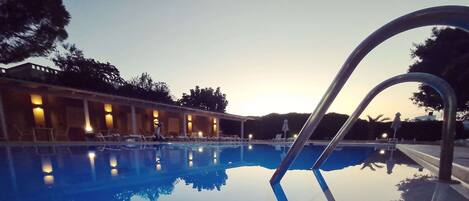 A swimming pool with clear water reflecting the surroundings.