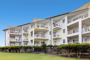 Guests can enjoy balconies with windows and doors overlooking a beautifully maintained lawn.