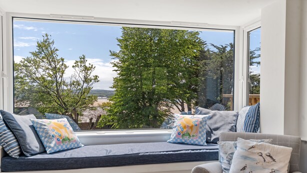 A room with a large window seat, a cushioned bench, and a chair with patterned cushions. - Pen-Wethers -  Holiday Home that sleeps 8 guests  in 4 bedrooms (Rock)