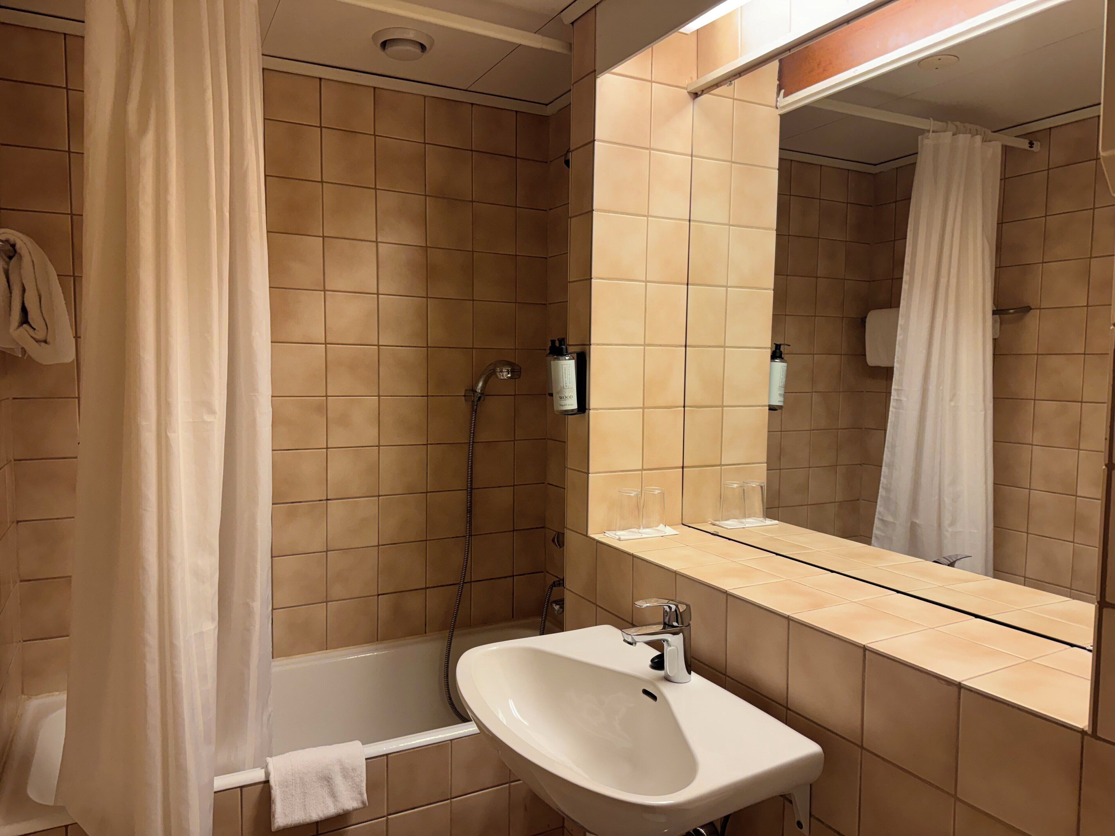 A bathroom with a bathtub, a sink, and a shower.