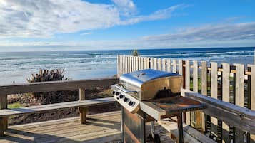 Enjoy outdoor dining or relaxation on this deck overlooking the beach.