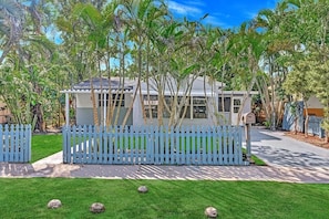 Surrounded by lush vegetation, this single-story house offers a serene retreat.