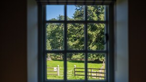 A window with a view of a green field and trees. - The Lodge at The Yair - Riverside comfort in the Scottish Borders (By Galashiels)