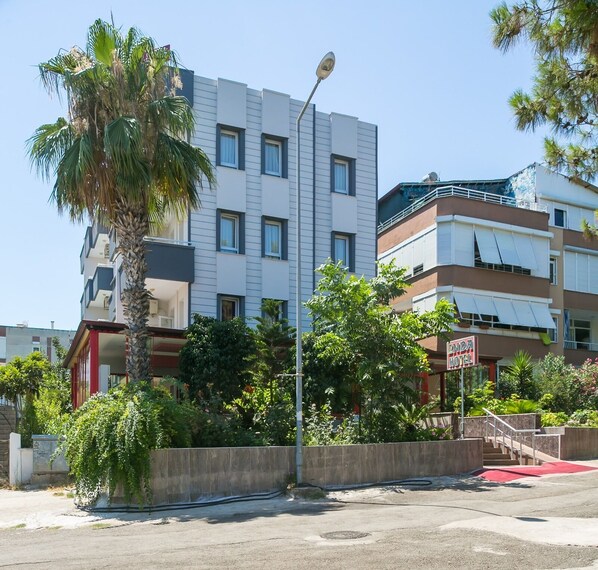 Un hôtel à l’architecture moderne, doté de nombreux balcons et d’une végétation luxuriante.