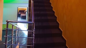 A staircase with a metal railing leading to a lower level. - Joclarif Hotel (Zaria)