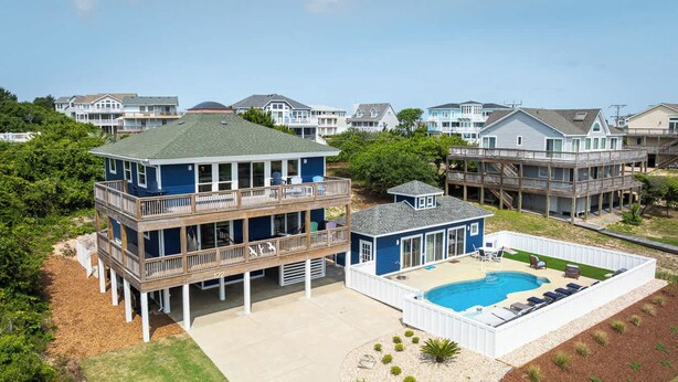 A two-story house with a pool, a deck, and a covered patio. - Newly Renovated Semi-Oceanfront Duck Home w/Pool (Duck)