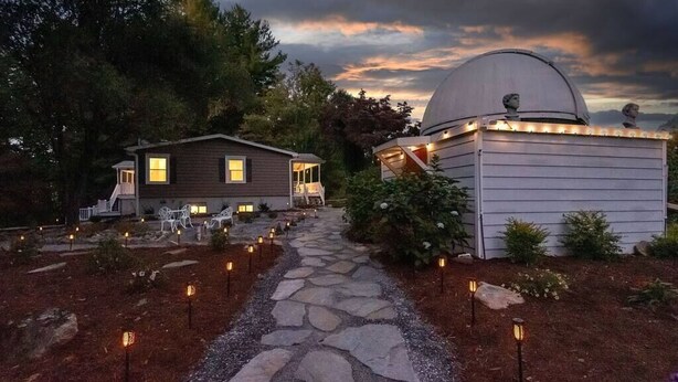 A house with a stone pathway leading to a dome-shaped observatory, surrounded by trees and outdoor lighting. - 40 Acres w/Waterfalls, Vineyard, Stream, 5 bedroom (Moravian Falls)