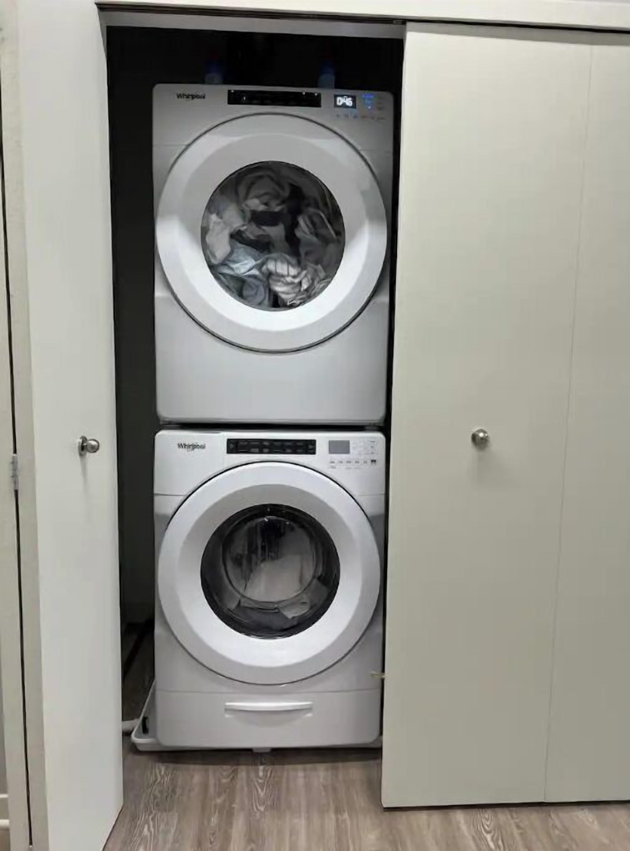 A laundry room with two stacked front-loading washing machines.