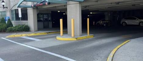 A parking garage entrance with a clear sign indicating 'CLEARANCE' and a disabled parking symbol.
